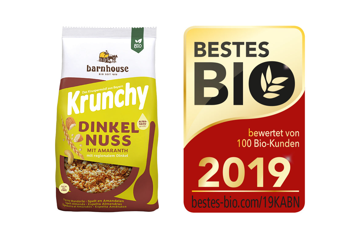 Packshot von Krunchy Dinkel-Nuss mit Amaranth, daneben das Siegel für "Bestes Bio 2019".
