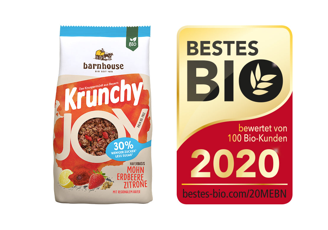 Packshot von Krunchy Joy Mohn-Erdbeere-Zitrone, daneben das Siegel für "Bestes Bio 2020".