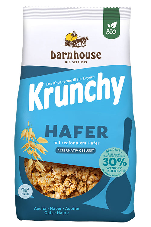 Packshot vom blauen Beutel Krunchy Hafer weniger Zucker von Bio-Knuspermüsli-Hersteller Barnhouse mit Neu-Button