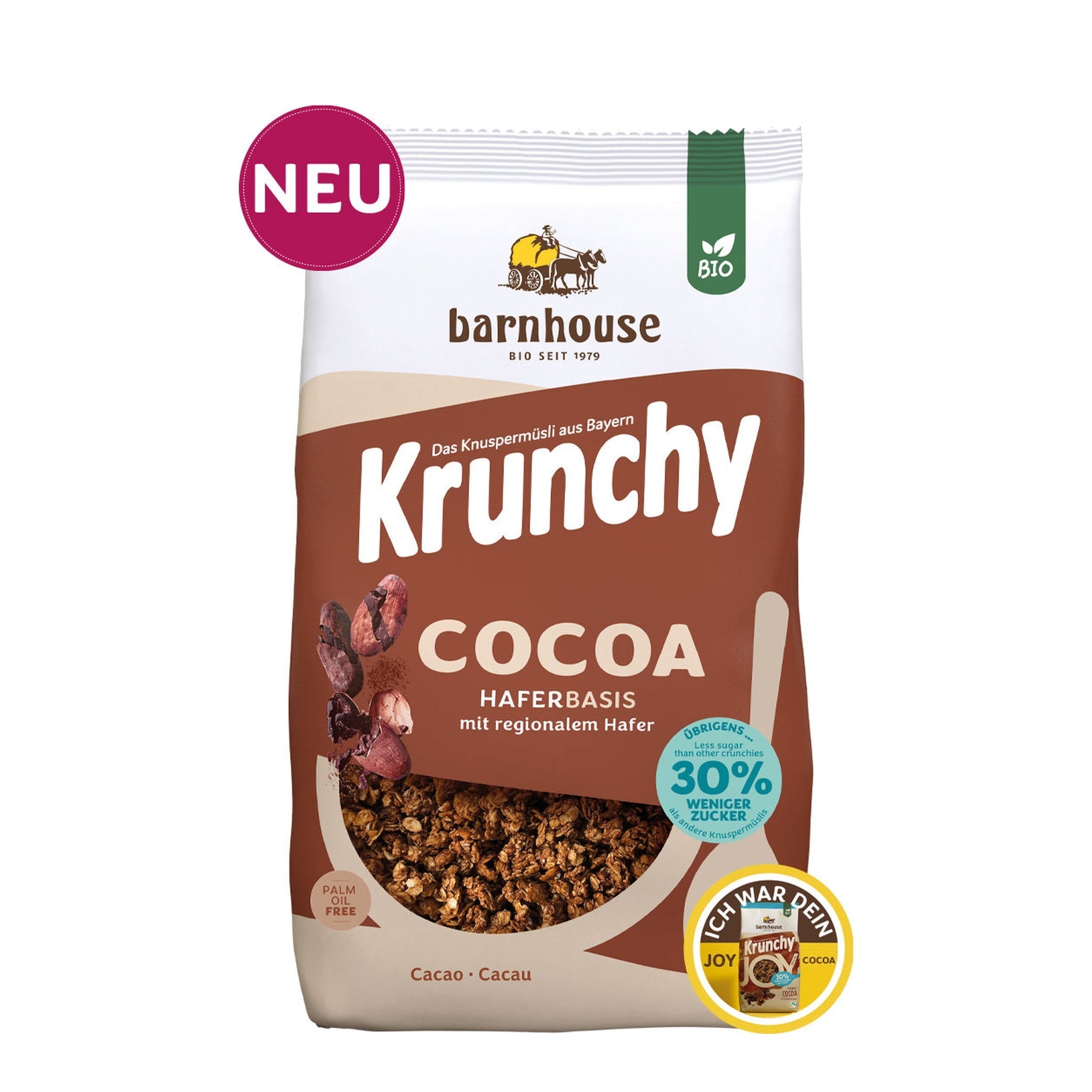 Packshot vom braun-beigen Beutel Krunchy Cocoa weniger Zucker von Bio-Knuspermüsli-Hersteller Barnhouse mit "Neu"und "Ich war dein Joy Cocoa" Button